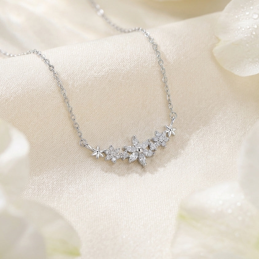 Delicate flower bar pendant made with 925 sterling silver, on a light background