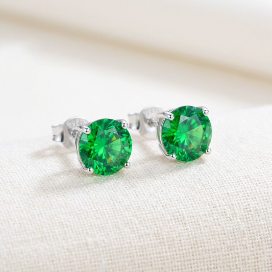 925 Sterling silver stud earrings with bright emerald green crystals on a light background