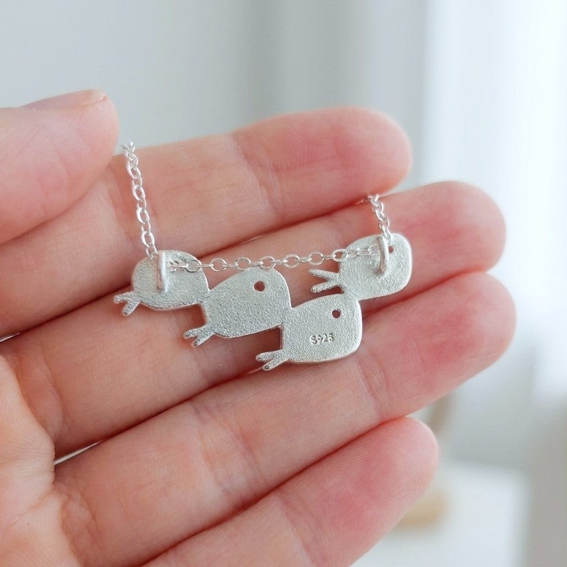 The back of a silver fish necklace showing the S925 stamp