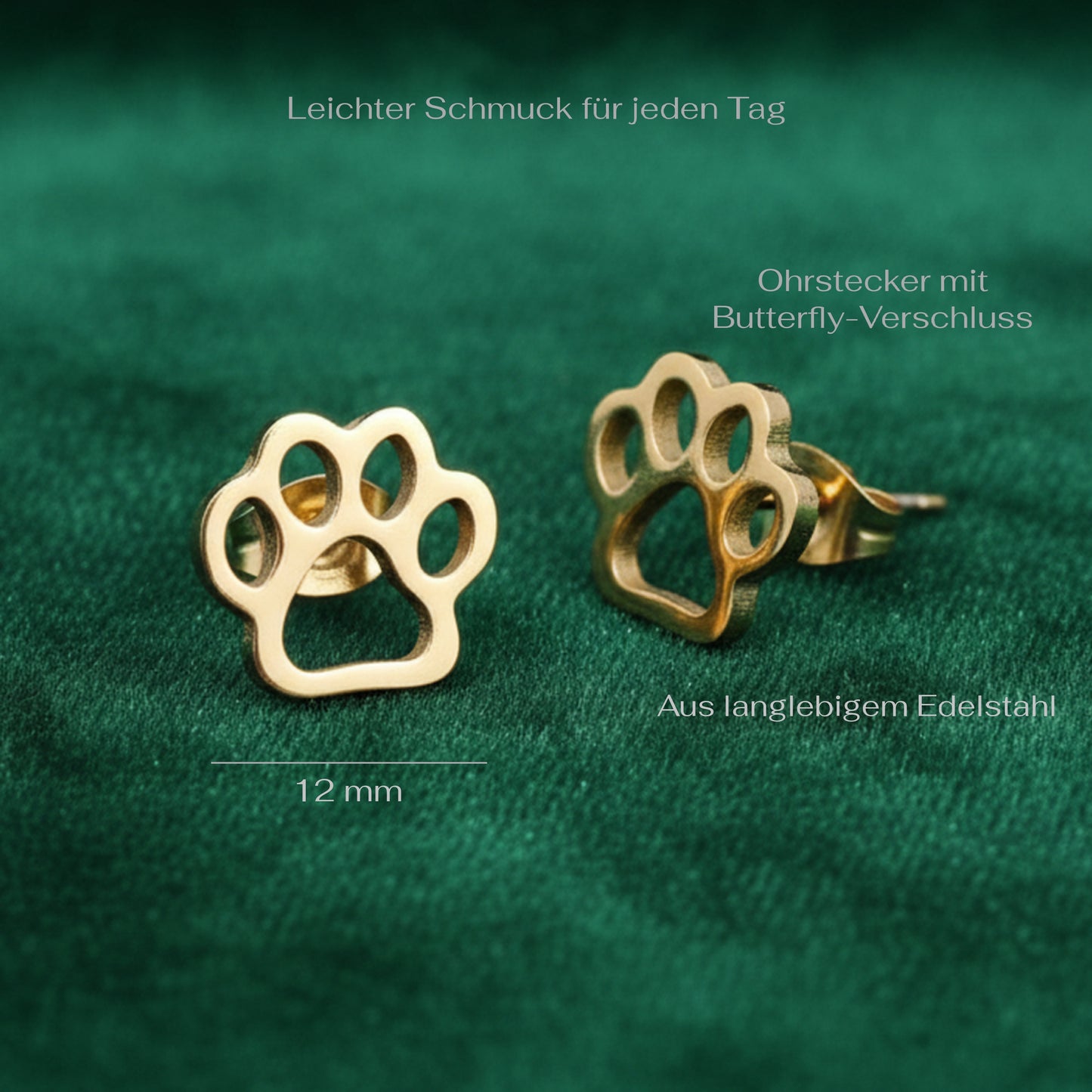 Gold stainless steel paw-shaped earrings on a green fabric background