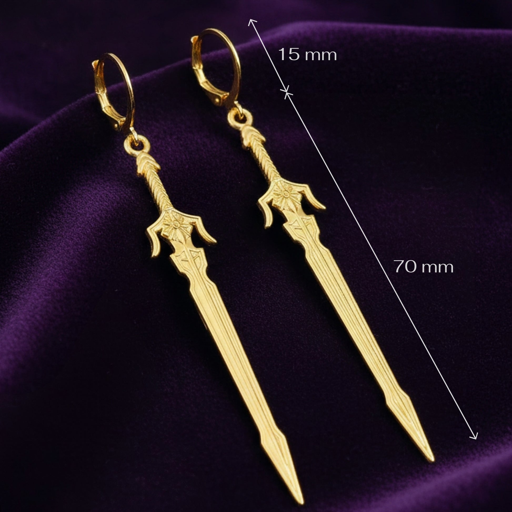 Medieval style fantasy long gold sword earrings with leverback hoops on a purple background with measurements