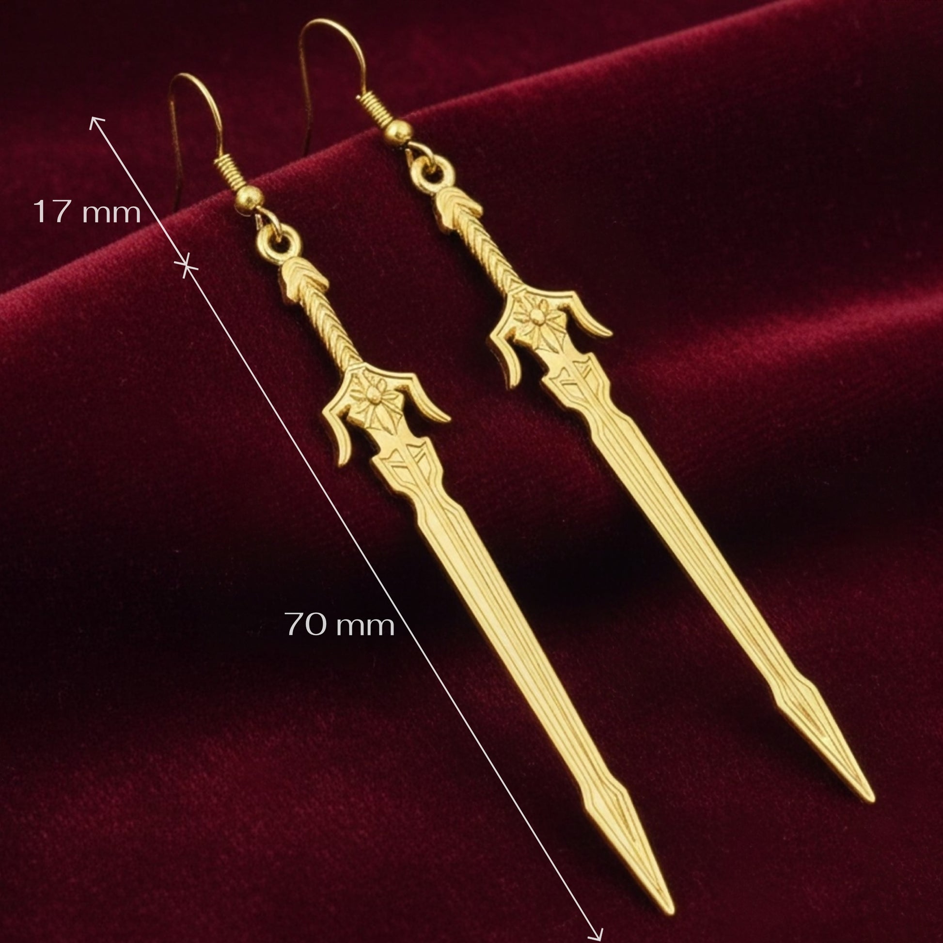 Medieval style fantasy long gold sword earrings with hooks on a red background with measurements