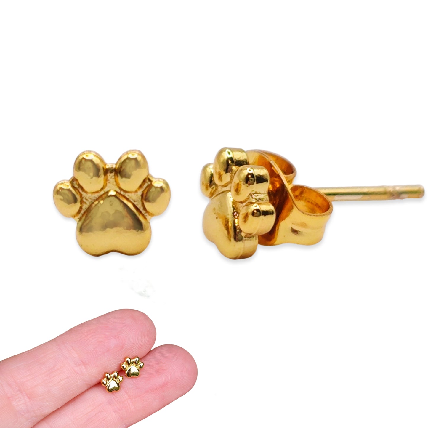 Gold paw print earrings on a white background with a hand holding earrings for scale.