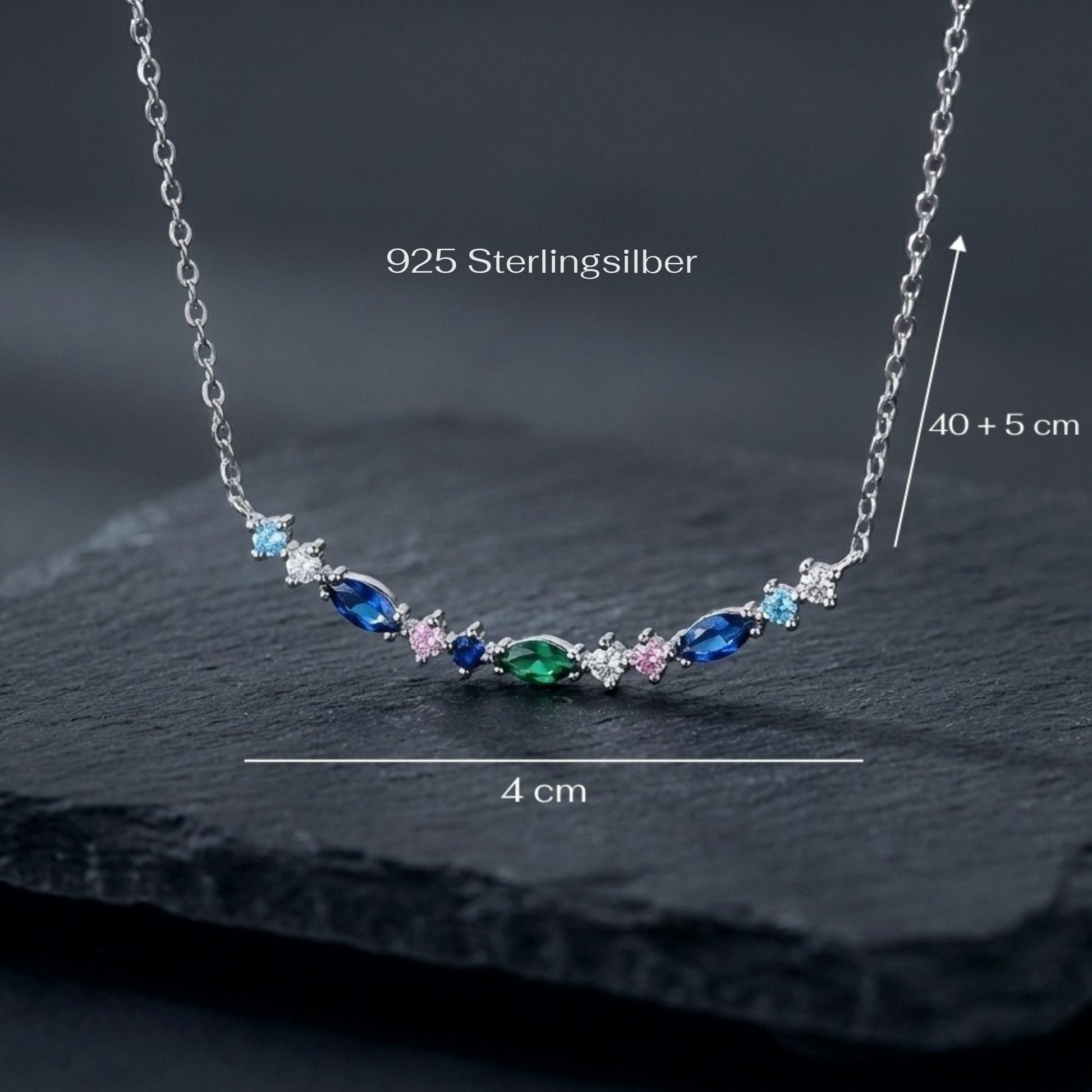 Silver necklace with colorful stones on a dark surface, labeled '925 Sterlingsilber'.