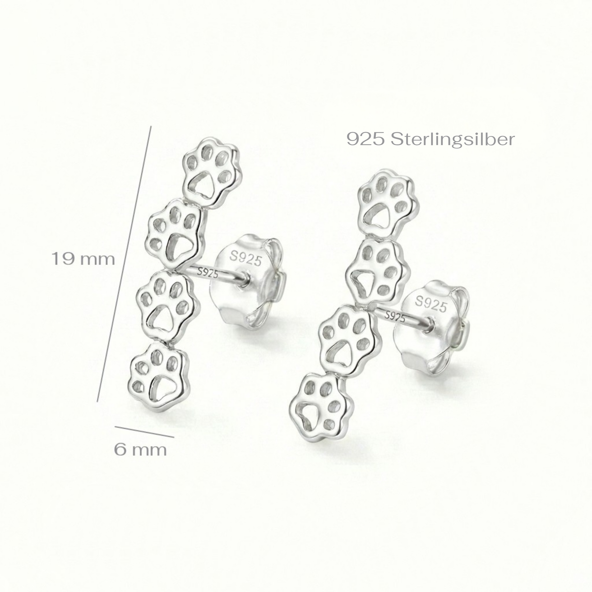 Silver paw print earrings with measurements on a white background