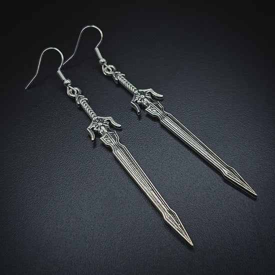 Video of long silver sword earrings with a medieval fantasy style
